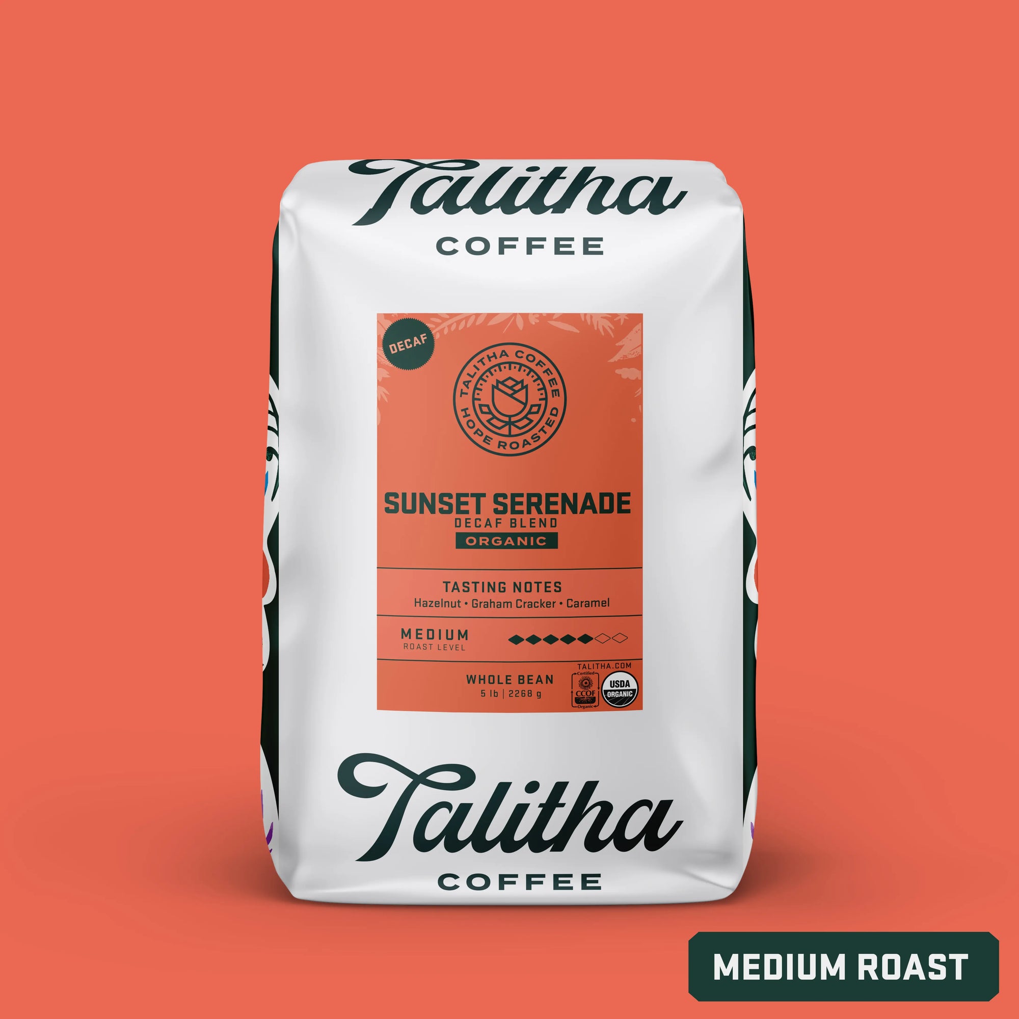 Packaging for Talitha Coffee's Sunset Serenade decaf blend. The bag is white with a floral pattern and a label that includes the product name, tasting notes, and 'medium roast' designation.